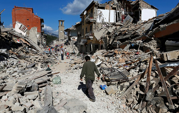 A man walks amidst rubble following an earthquake in Pescara del Tronto, central Italy, August 24, 2016. REUTERS/Remo Casilli